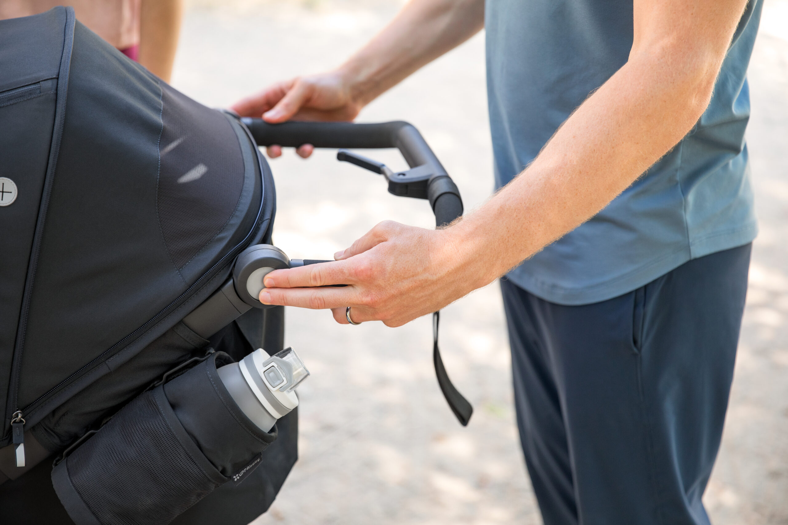 Stroller with outlet adjustable handle