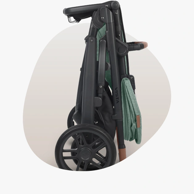 Vista V2 stroller (Gwen - green mélange, carbon frame, saddle leather) folded and standing on its own with the Toddler seat attached