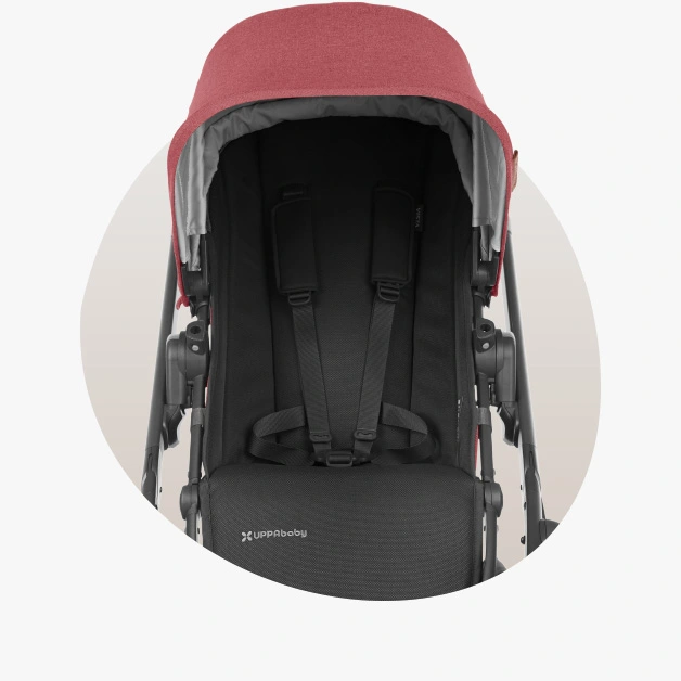 Vista V2 stroller (Lucy - rosewood mélange, carbon frame, saddle leather) showcasing the easy to use no -rethread harness that can be tightened or loosened in a singular motion
