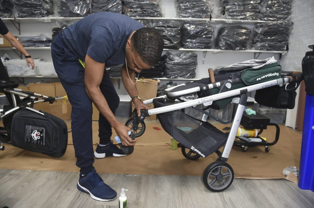 A member of the UPPAbaby Tech Team servicing an UPPAbaby Cruz stroller.