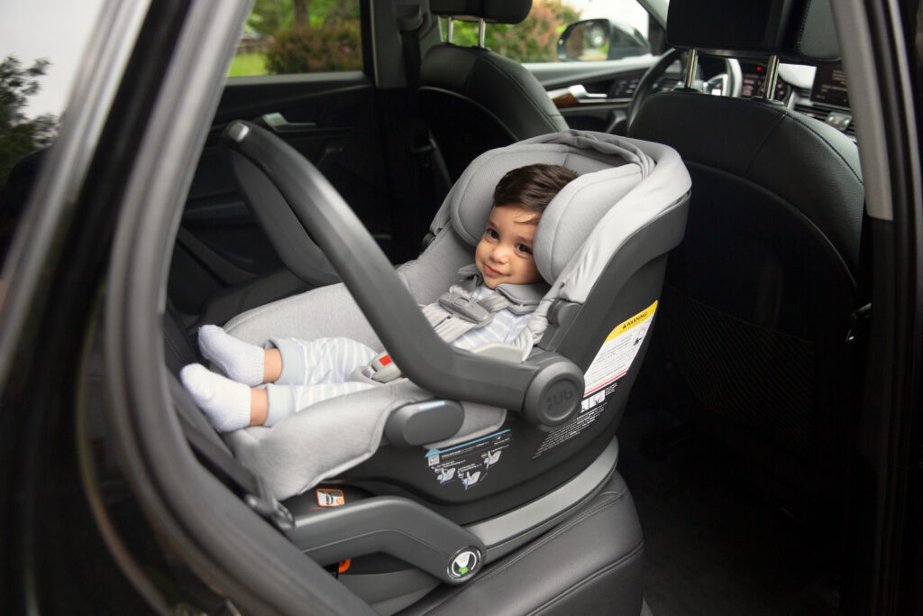 A little one secured safely into an UPPAbaby Mesa V2 Infant Car Seat.