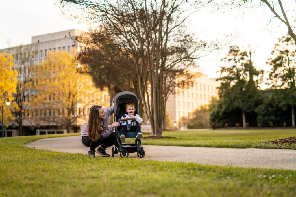 A mother with her son in an UPPAbaby Minu V2 | Greyson | Charcoal Mélange | Carbon Frame | Saddle Leather.