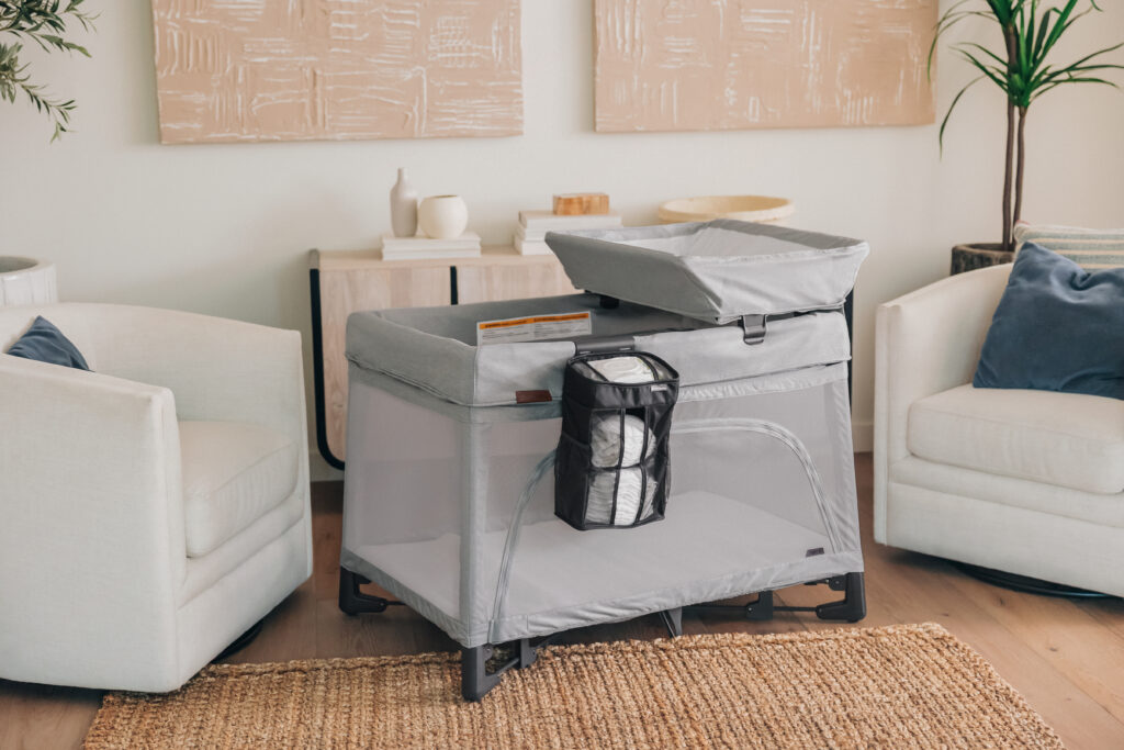 An UPPAbaby Remi Playard in a family living room – Stella – Grey Mélange.
