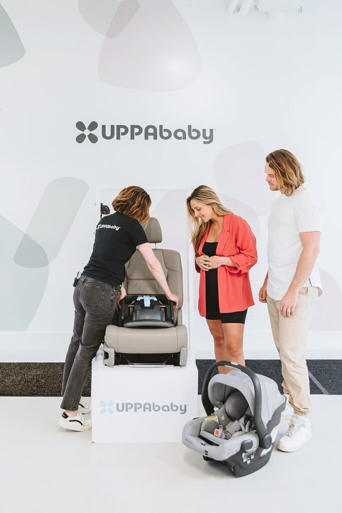 A member of the UPPAbaby Tech Team servicing an UPPAbaby Mesa V2 Infant Car Seat at a local Tune-Up Gear-Up event.