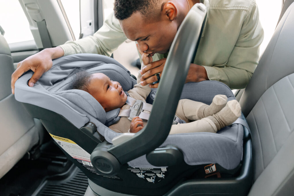 A child secured comfortably in an UPPAbaby Mesa V2 Infant Car Seat.
