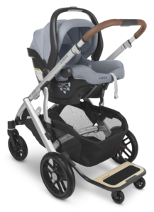 An UPPAbaby Vista V2 Stroller with the UPPAbaby Mesa V2 Infant Car Seat configuration | Gregory | Blue Mélange | Silver Frame | Saddle Leather | Piggyback ride-along board accessory