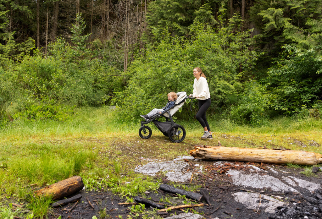A mother adventuring with her little one in an UPPAbaby Ridge Stroller.