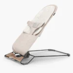 The Mira 2-in-1 bouncer (Charlie - Sand Mélange, Black Frame, Walnut Wood) and included cozy seat liner is designed to grow with baby, from use at birth to their toddler years