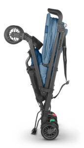 UPPAbaby G-LUXE stroller in folded position in Charlotte Coastal Blue Mélange, demonstrating the stroller's space-saving design for urban living