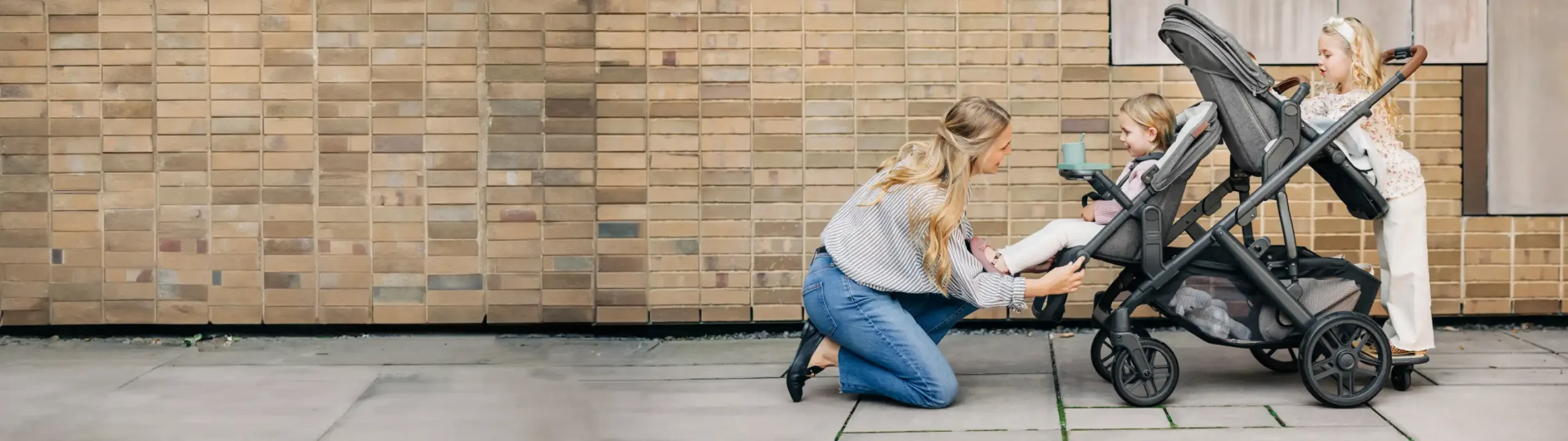 Mother adjusts footboard of stroller