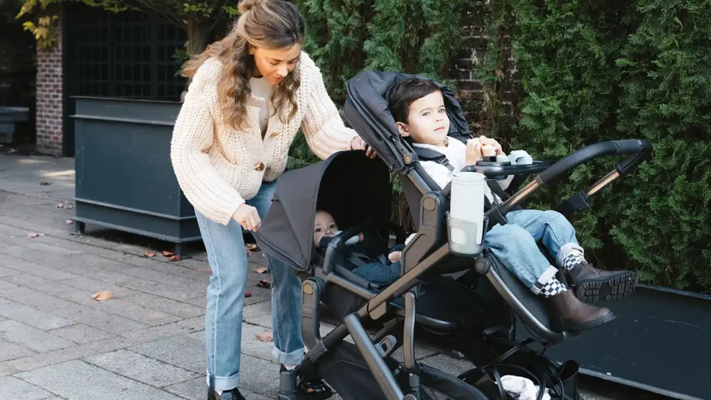 A parent adjusts the RumbleSeat canopy